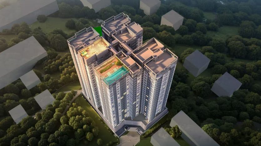 Aerial view of a luxury apartment complex with amenities like a pool and rooftop garden.
